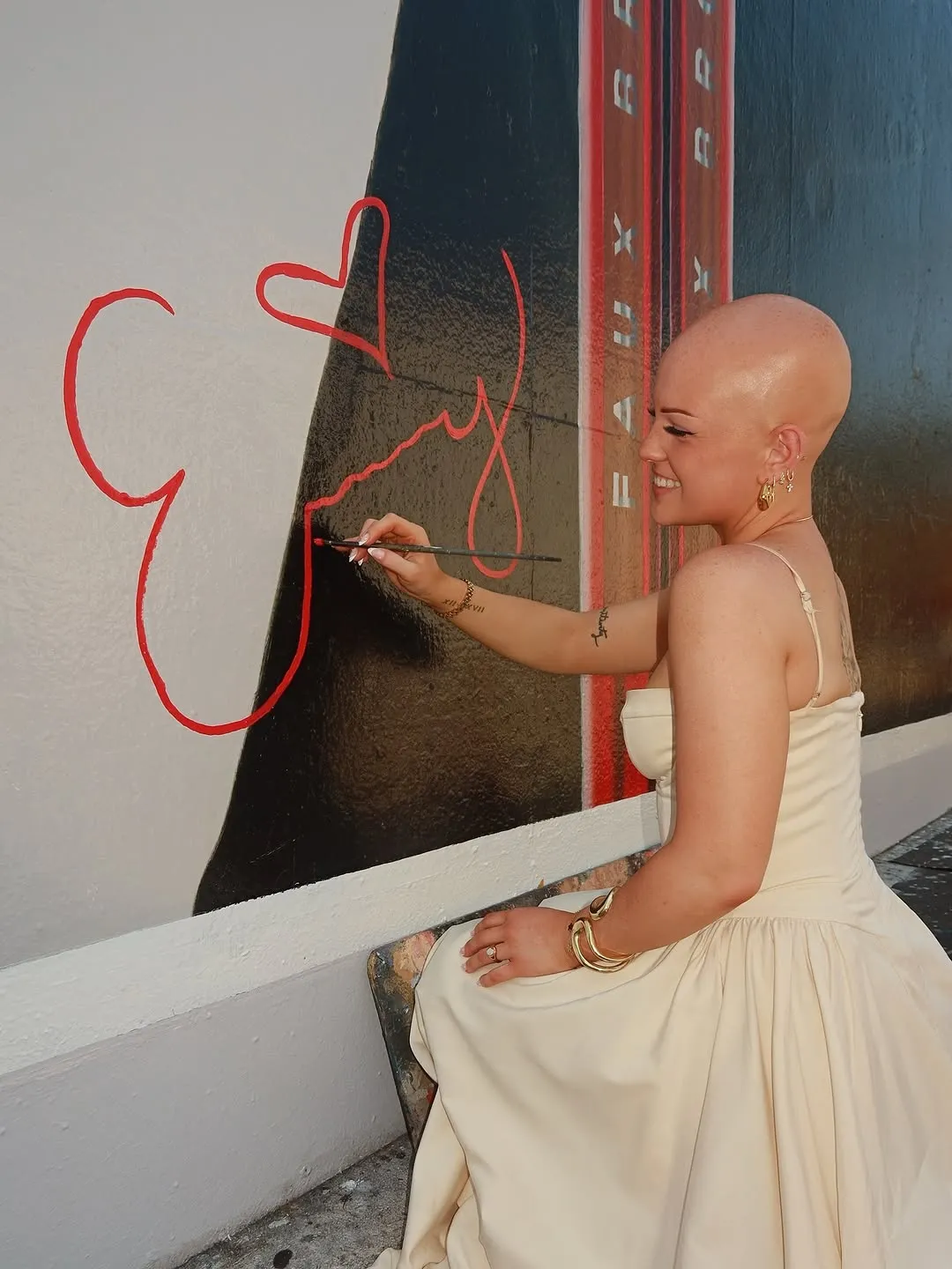 Emmy looking up at the Beauty Beyond Barriers billboard