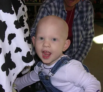 Emmy as a baby wearing a pink bandana