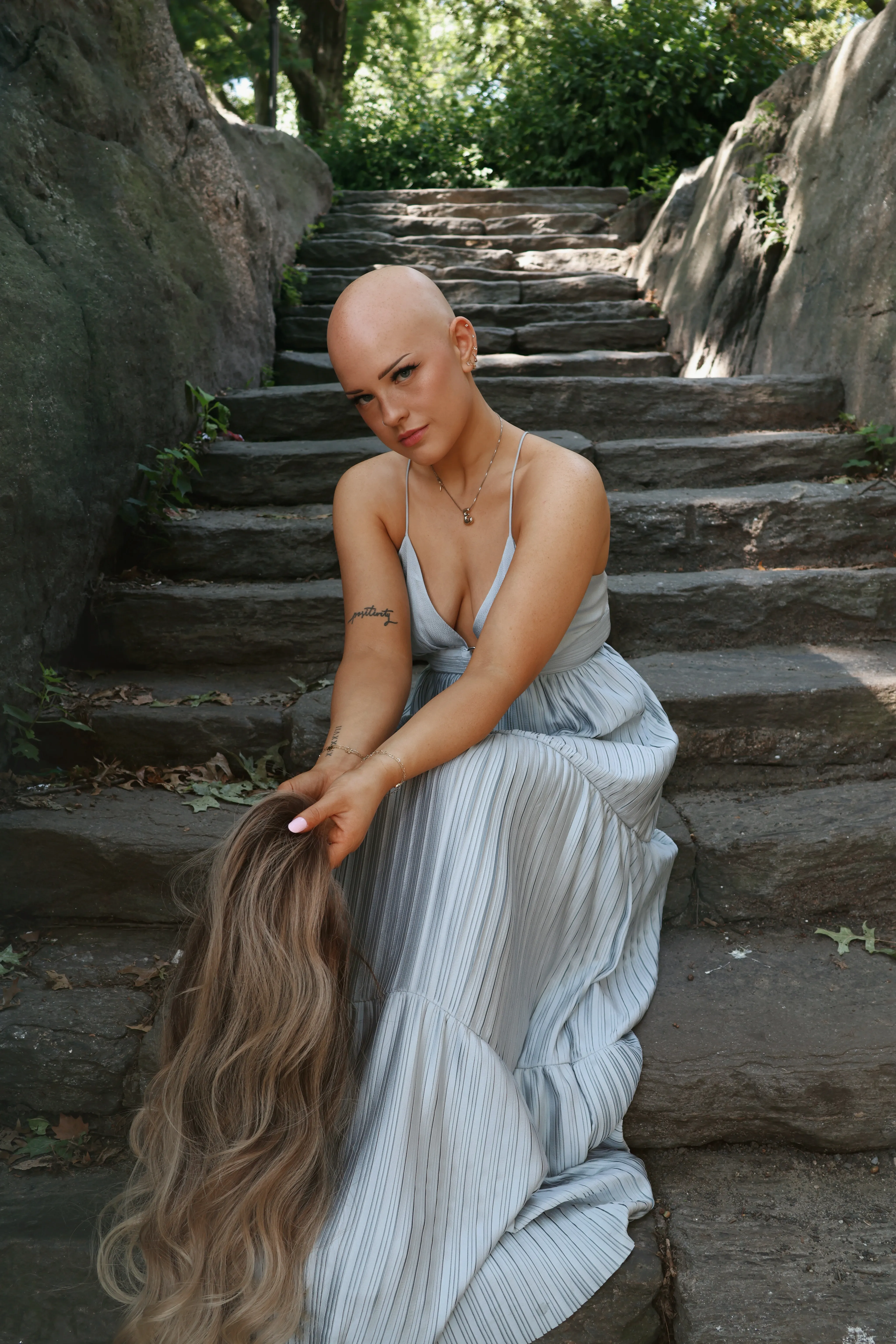 Emmy standing confidently with her bald head showing